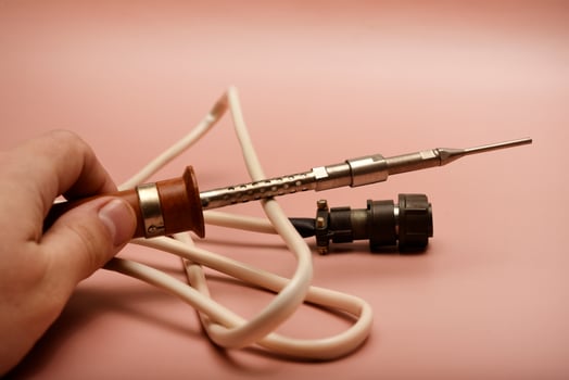 An ancient soldering implement displaying a silver tip photo