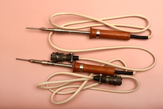 A timeworn soldering tool equipped with a silver tip photo