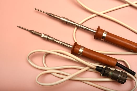 A historic soldering instrument with a silver head photo