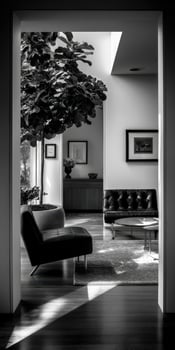 Black and white photo of a living room with a tree