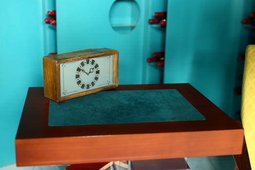 A Vintage Clock Sitting Gracefully on a Retro Table in a Colorful and Inviting Room photo