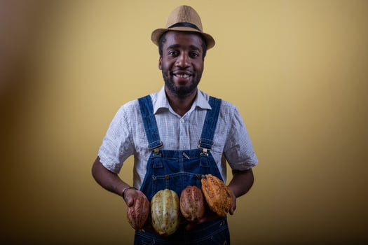 Portrait of a smiling African farmer with cocoa beans, African cocoa producer photo