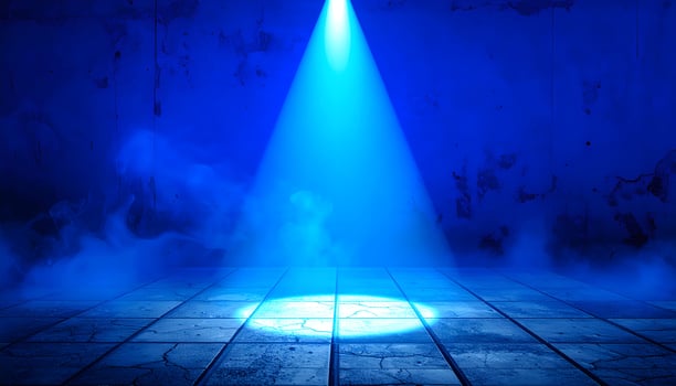 Dramatic blue spotlight shining on empty tiled stage with smoky atmosphere and grunge wall photo