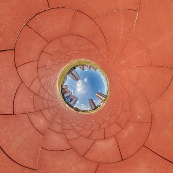 A circular view of a city skyline from inside a circular tunnel photo