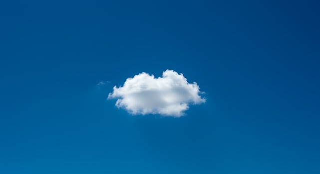 A single cloud floating in the blue sky photo
