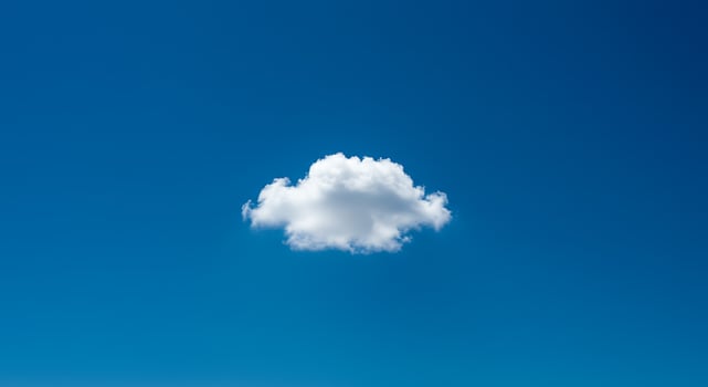 Single cloud in blue sky photo