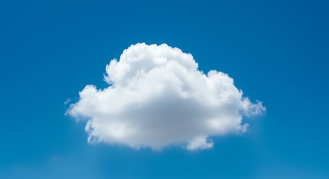 A single white cloud is seen in the blue sky photo