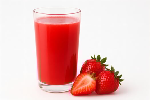 A glass of strawberry juice next to a strawberry photo