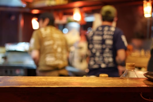 Wooden tabletop of Izakaya restaurant blurred scene photo