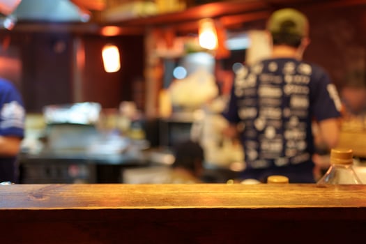 Wooden table of traditional Izakaya restaurant blurred scene photo