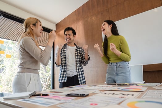 Diverse team celebrating success in a modern office, showcasing teamwork and collaboration. photo
