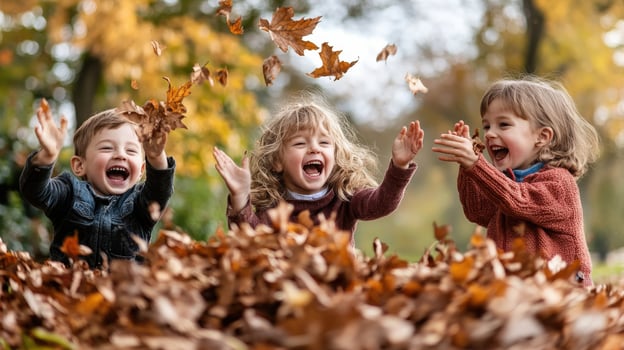 Three children playing in a pile of autumn leaves. photo