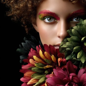 Model showcases vibrant floral makeup with bold colors and textures photo
