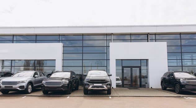 Modern car dealership exterior with parked vehicles showcasing automotive retail photo