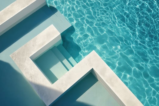 Minimalist pool design with clear water, geometric concrete steps casting shadows on the aqua surface, capturing bright sunlight and creating a tranquil, refreshing atmosphere photo