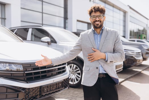 Car Salesman Showing New Vehicle to Potential Customer in Dealership photo