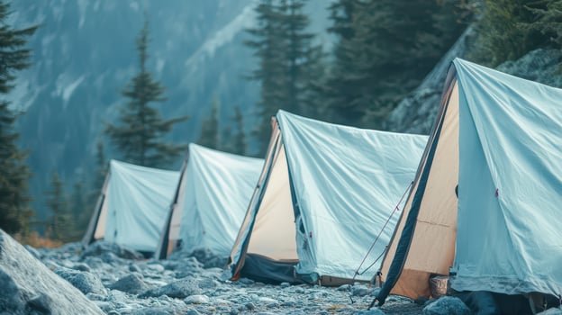 Tents pitched by rocky mountains photo