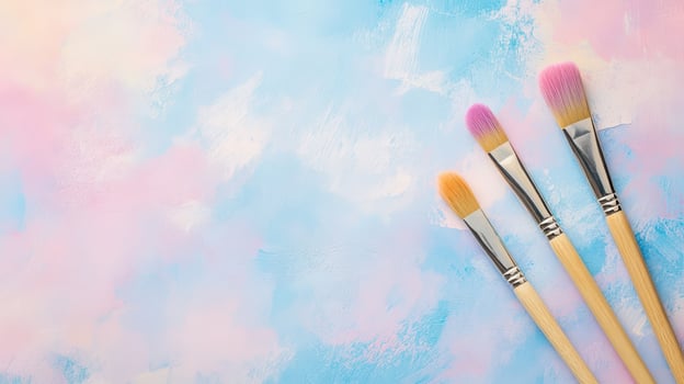 Colorful paintbrushes on pastel background photo