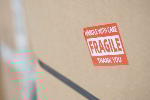 Careful handling of fragile package with warning label photo