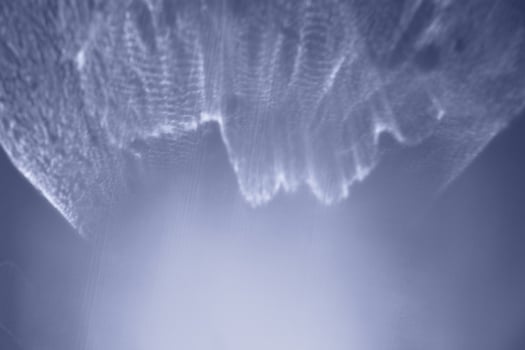 Abstract white sunlight lines on blue background, natural glare from lights, white blue monochrome photo, gradient color, blurred bokeh texture as Glittering aesthetic textured pattern, future dusk photo