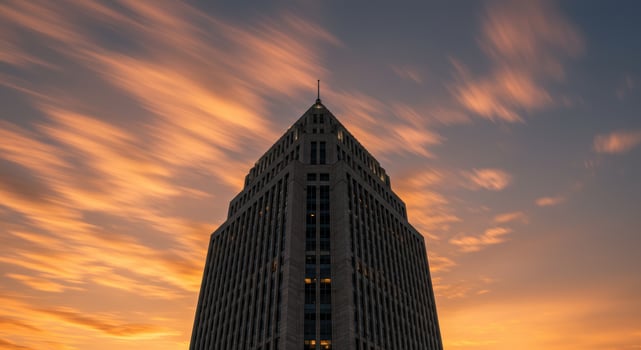 Modern Skyscraper Against Dramatic Sunset Sky photo