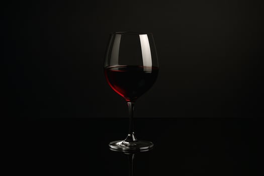 a glass of red wine on a black background photo