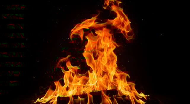 Bright Orange Fire Flame Glowing on Black Background photo