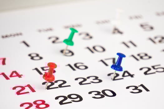 date with push pin on calendar photo
