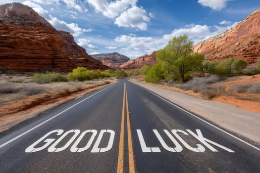 Good luck sign painted on scenic desert road leading to success photo