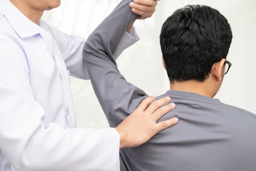 Physical therapy therapist doctor treat perform pain young man photo
