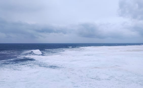 Dramatic seascape featuring powerful waves under a stormy sky. Evokes strength, resilience, or challenge. Ideal for themes like nature, weather, or overcoming obstacles. photo