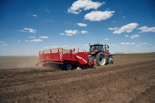 Riding, side view.. Agricultural machinery, tractor on the field. Conception of harvest photo