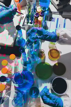 A table with many different colored liquids and test tubes photo