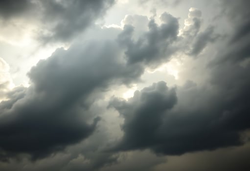 cloudy sky with a plane in the foreground photo