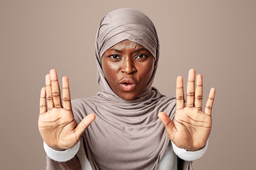 No Means No. Annoyed Black Muslim Lady In Hijab Making Refuse Stop Gesture With Two Opened Palms, Rejecting Unwanted Things, Saying Enough, Standing Over Light Studio Background, Copy Space photo
