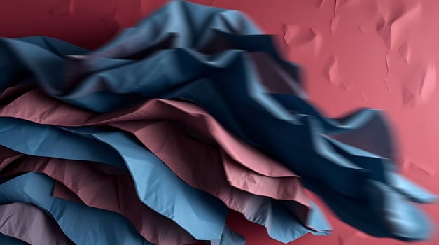 Abstract composition of layered fabric in shades of blue and pink on a red background photo
