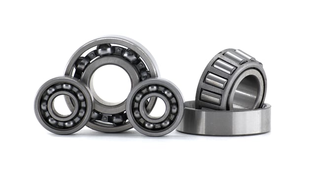 Set of ball bearings and roller bearings lying on white background photo