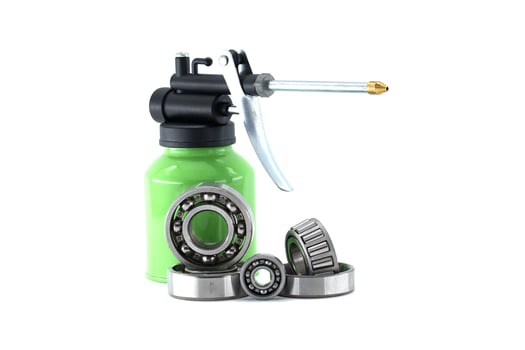 Green Oil Can with Metal Bearings on White Background for Industrial Use photo