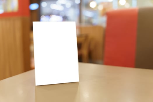 blank white card on table in restaurant photo