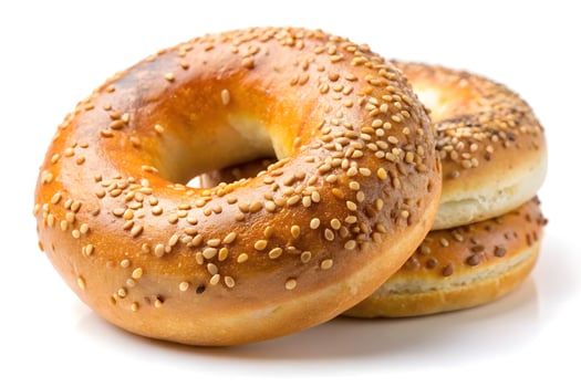 Freshly Baked Sesame Bagels Stacked on White Background photo
