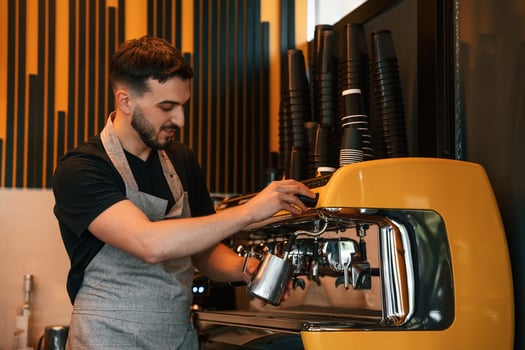 Pours, a drink by using special machine. Man is serving delicious street food photo