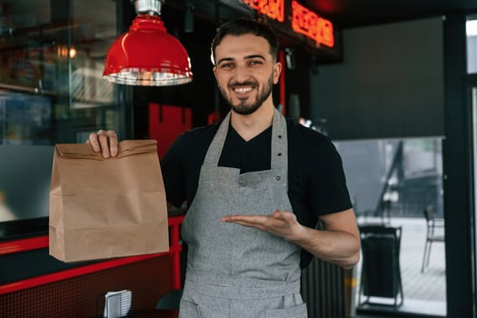 Order in package is ready. .Man is serving delicious street food photo