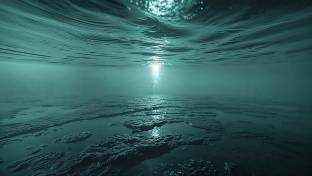A dark underwater scene with water and rocks photo