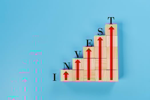 Conceptual image of the word invest formed by wooden blocks stacked symbolizing photo