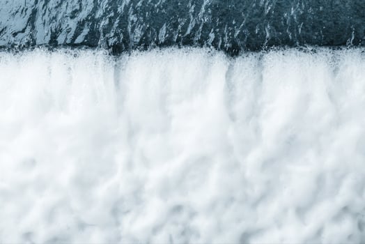 A Stunning of Water Flowing Over Rocks photo
