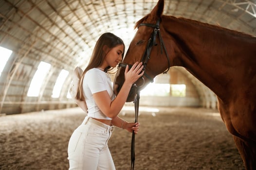Embracing ,the animal. ,Beautiful young, woman is with horse indoors photo