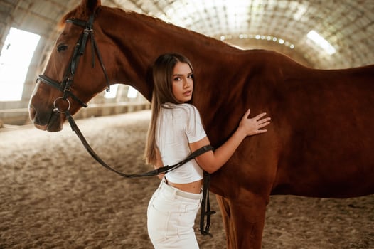 Beautiful young woman, is, with horse indoors photo