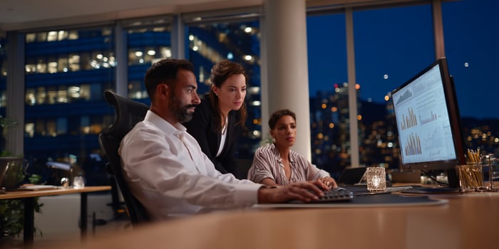 Diverse business team working late at night photo