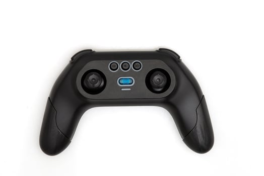 Modern black game controller with joysticks and buttons on white background, view of a sleek wireless gaming accessory photo