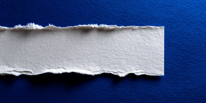 Ripped white paper on a blue background photo